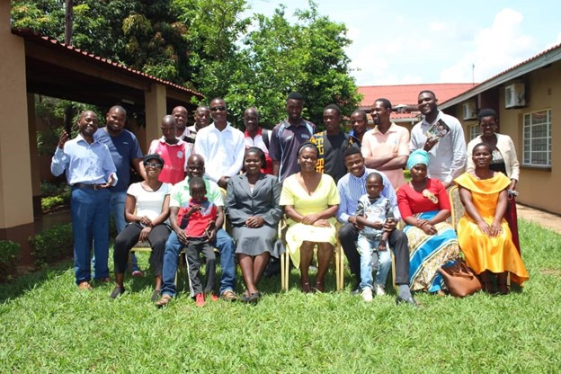 In Malawi, a group of people smile and pose