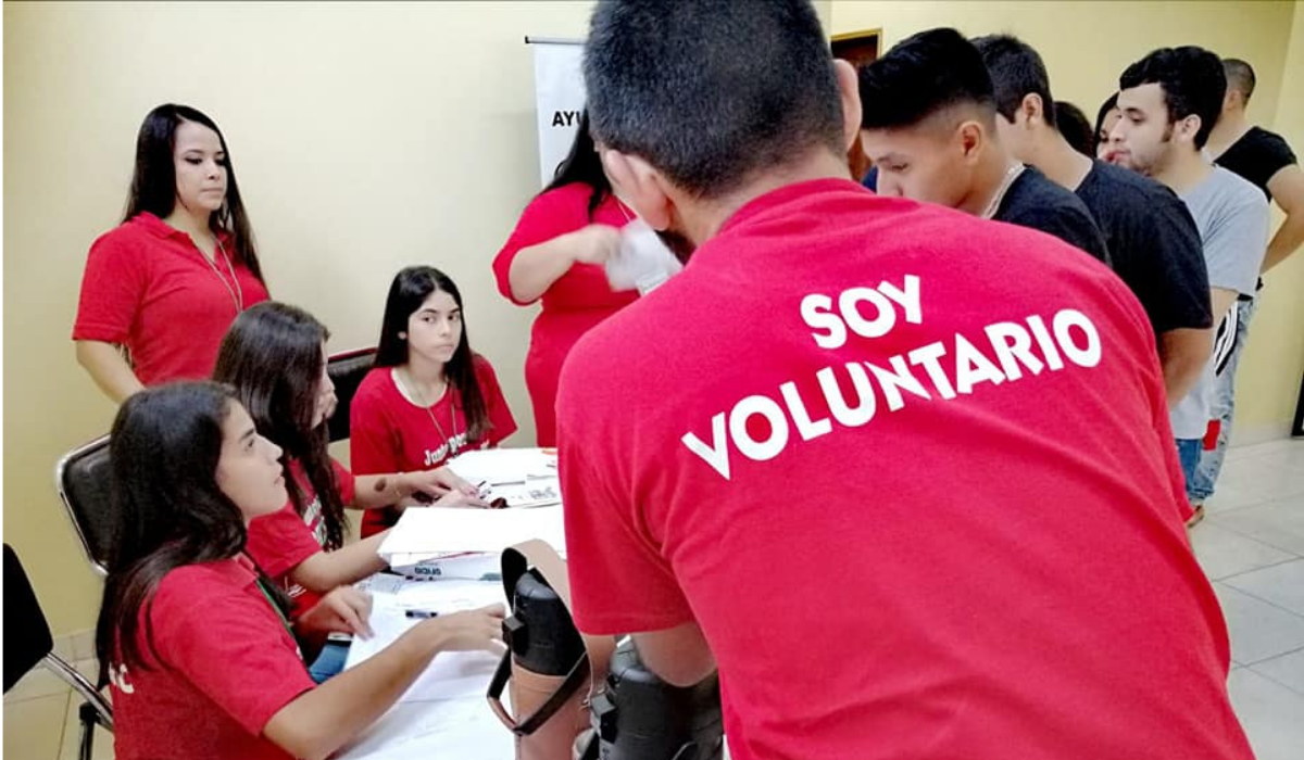 Volunteers in red shirts answer questions