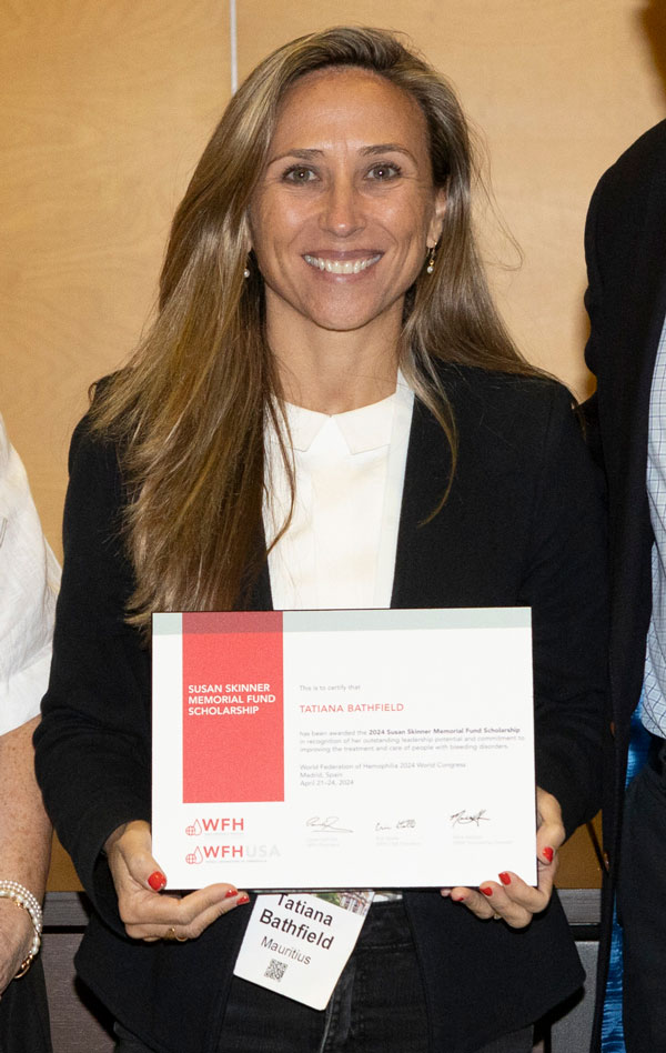 Tatiana receiving her scholarship at the SSMF event in Madrid during the WFH 2024 World Congress